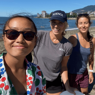 Youth ambassador takes a selfie on the beach with 2 volunteers